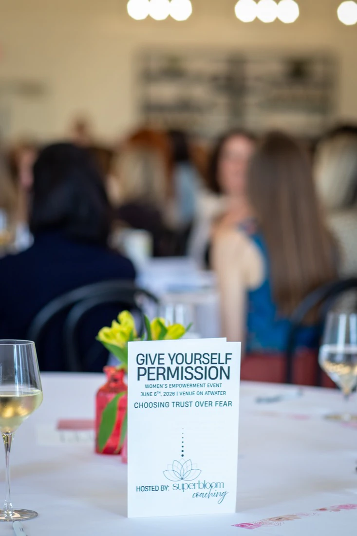 A Give Yourself Permission program card on a table, the room blurred behind it: choosing trust over fear.