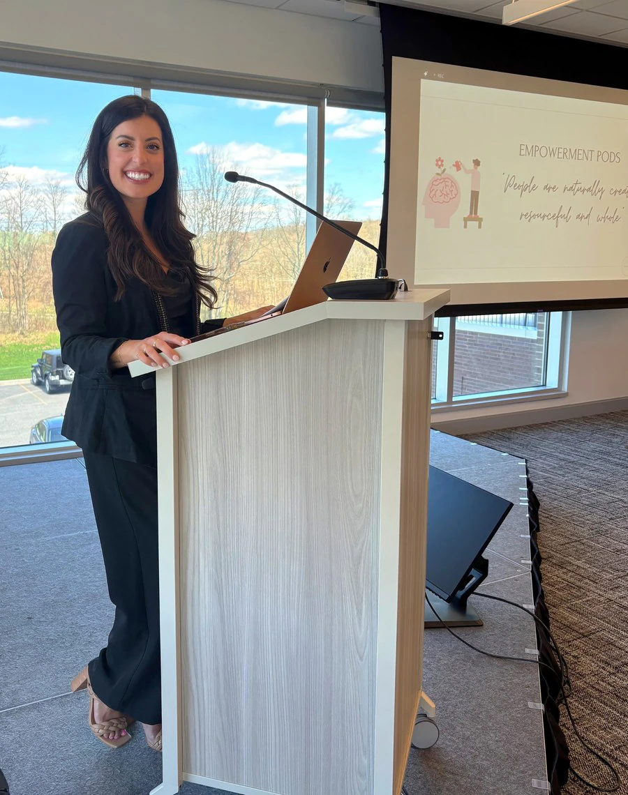 Alana smiling at the podium during her First American Equipment Finance keynote.